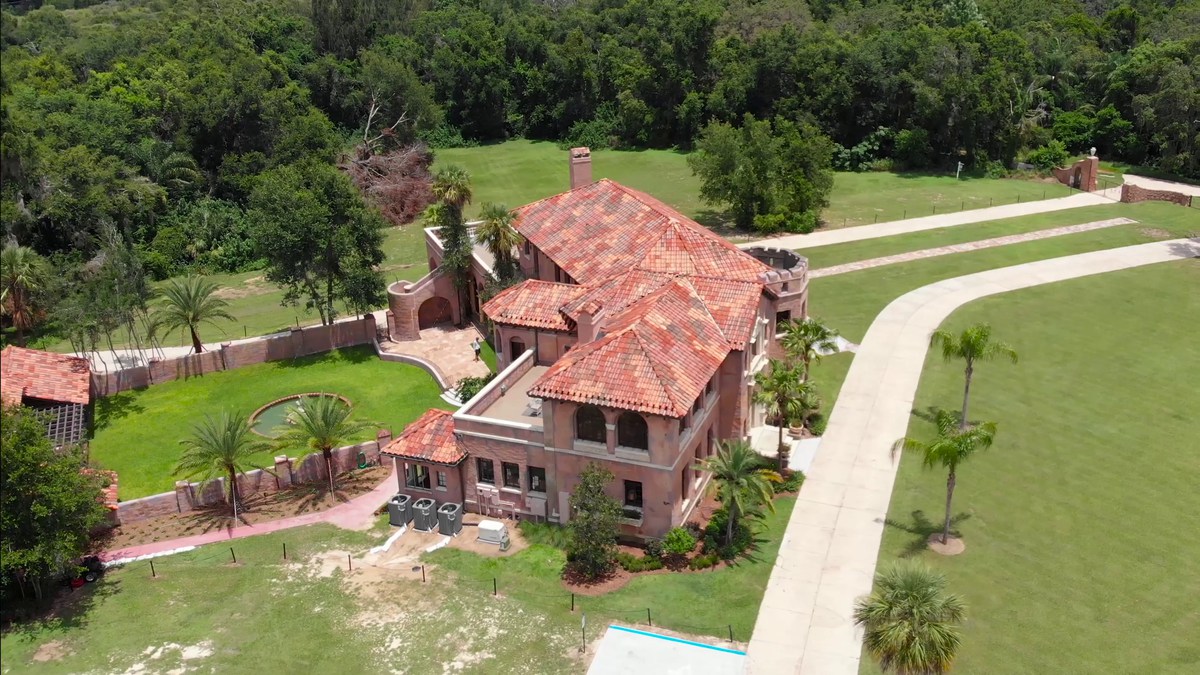 The Howey Mansion and its drive from the air, the estate set among lawns, palms and live oaks.
