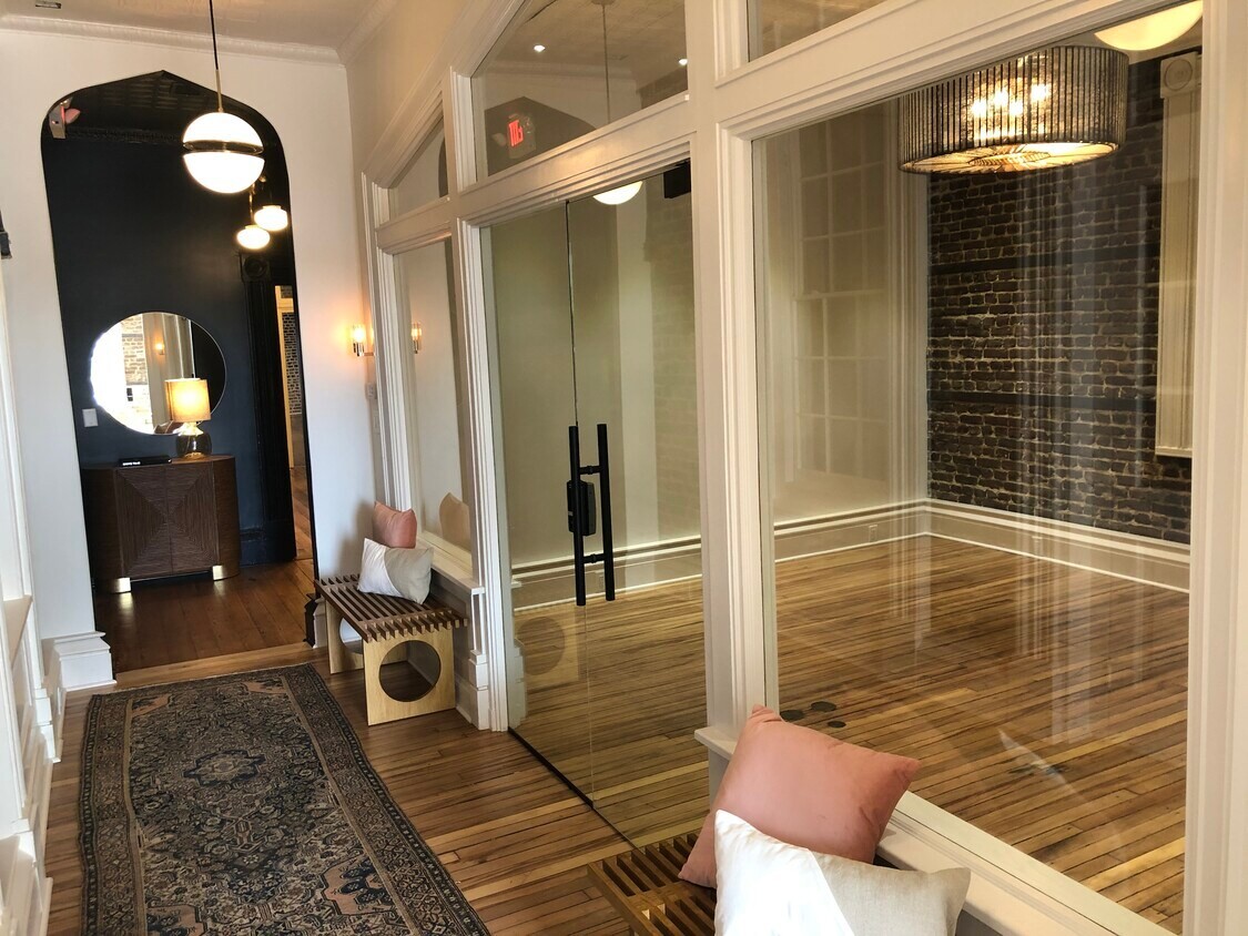 A daylit hallway on King Street with glass fronted office suites along one side.