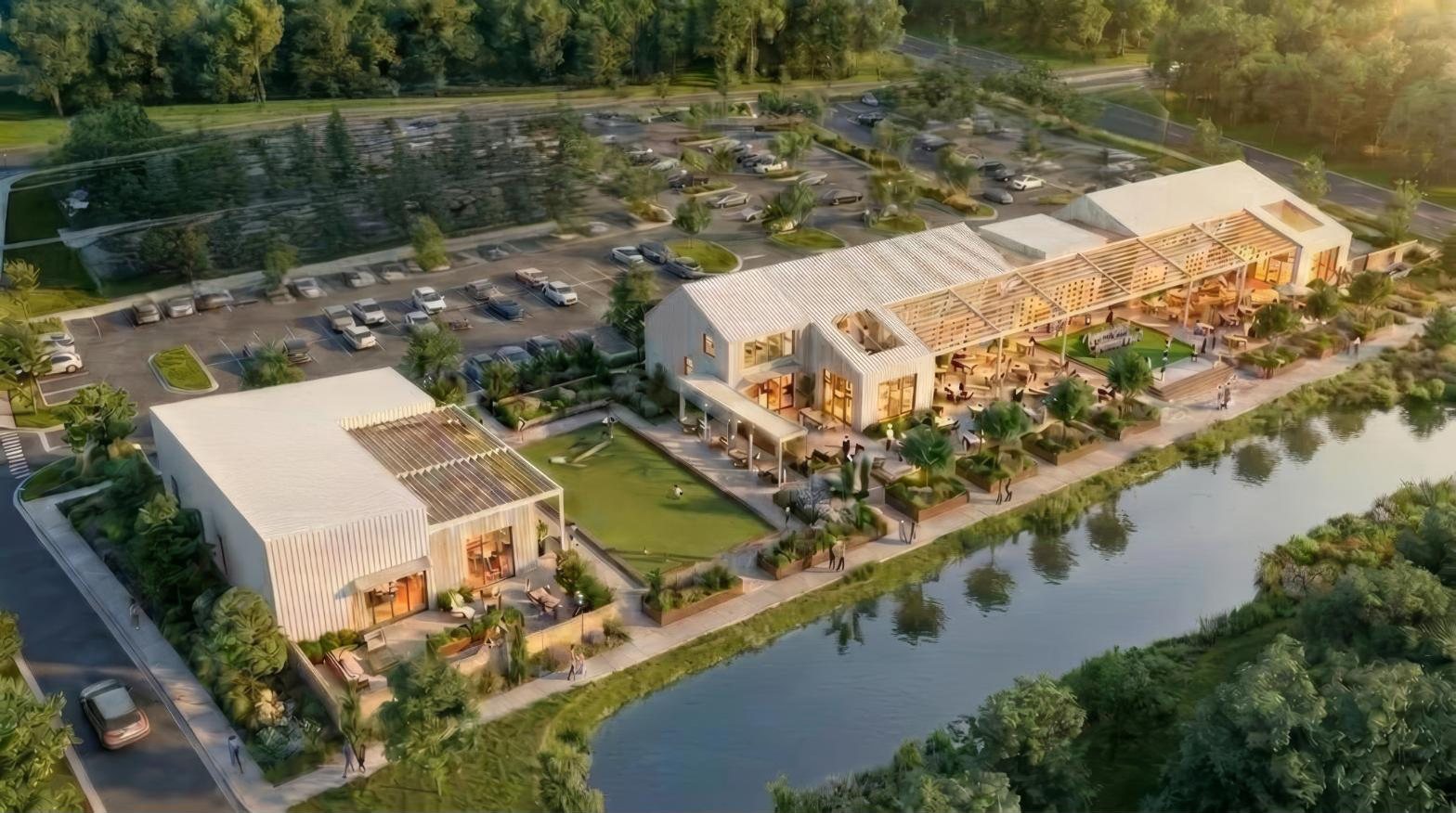 Concept rendering of PALMA at Nexton seen from above, the food hall and the event building set along the pond.