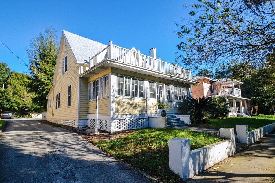 The yellow frame house with its upstairs deck at Thornton Park.